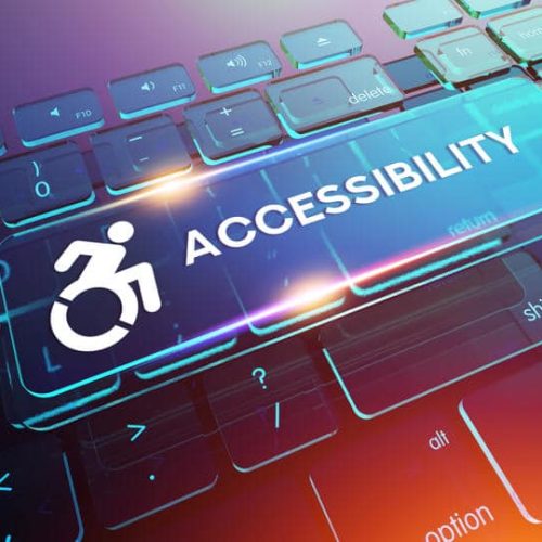 A keyboard featuring an oversized Accessibility key with a blue-highlighted wheelchair symbol.